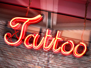 A neon tattoo sign to be displayed above a tattoo shop window