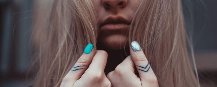 Girl with detailed tattoos on her thumbs