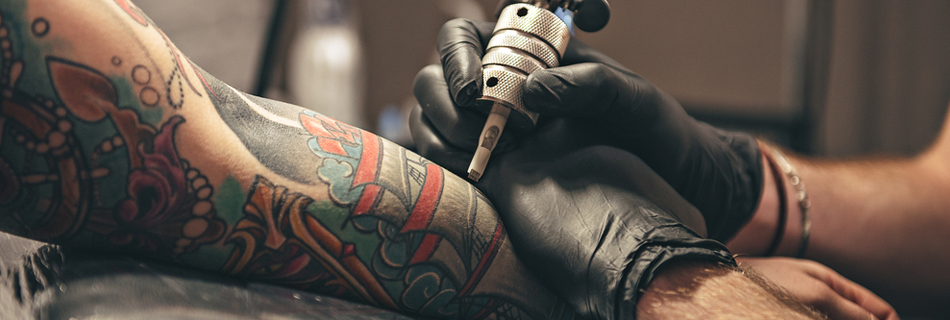 A traditional tattoo sleeve being worked on by a tattooist