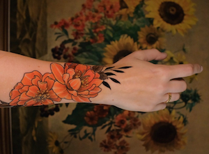 Tattooed forearm reaching out.